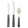 Set of three knives with black marbled handles on a white background